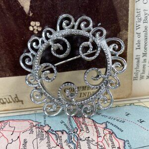 Sarah Coventry Swirling Filigree Circle Brooch Silver Tone
